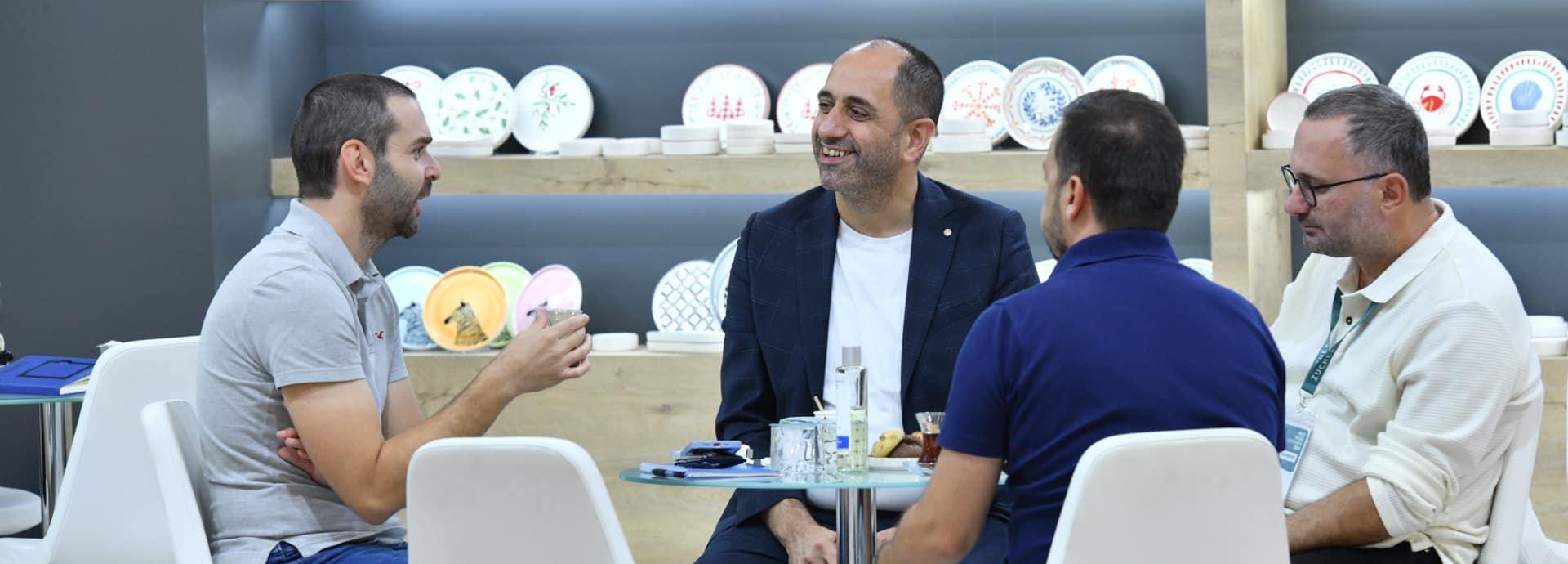Business meetings at the crowded exhibitor booth