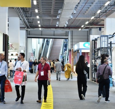 Visitors visit the stands and examine the products.